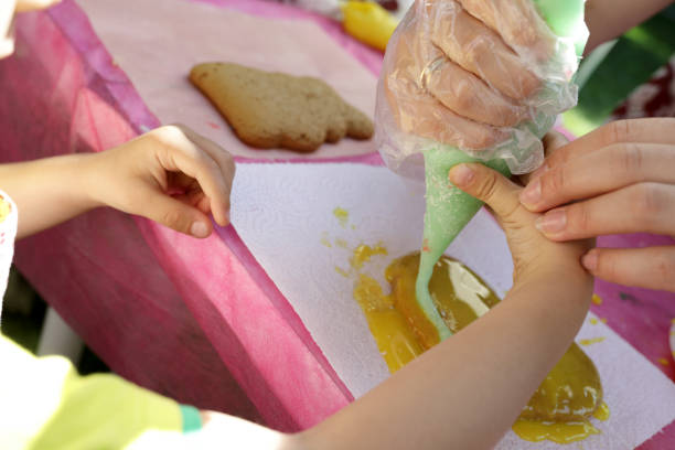 istock Person decorating gingerbread with cream 1042433258