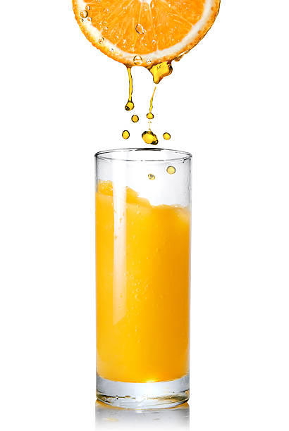 istock Juice pouring into glass from orange 104243540