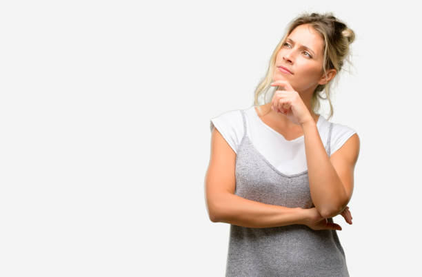 istock Young beautiful woman thinking and looking up expressing doubt and wonder 1042437370
