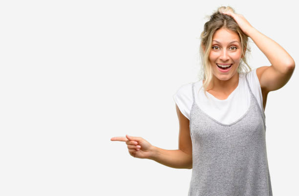 istock Young beautiful woman pointing away side with finger 1042437404