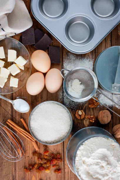 istock Baking background. Cooking ingredients for dough and wooden board on white rustic wood. Top view with copy space, recipe or culinary classes. 1042437782