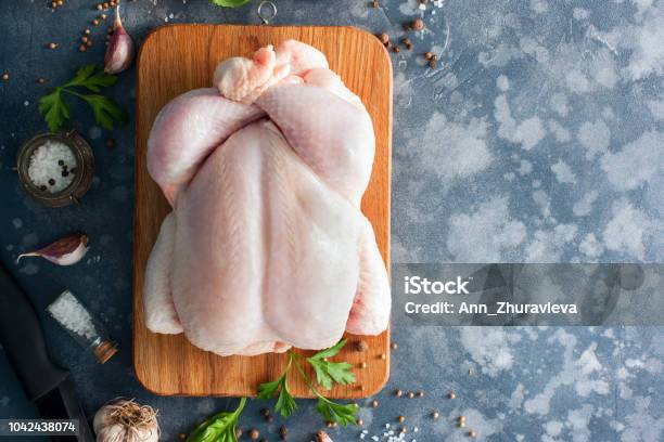 Whole Raw Chicken On A Wooden Board With Spices For Cooking Top View Horizontal Copy Space Stock Photo - Download Image Now