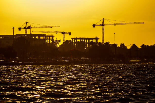 istock Cranes of a construction workshop at Izmir (Turkey) during sunset 1042446094