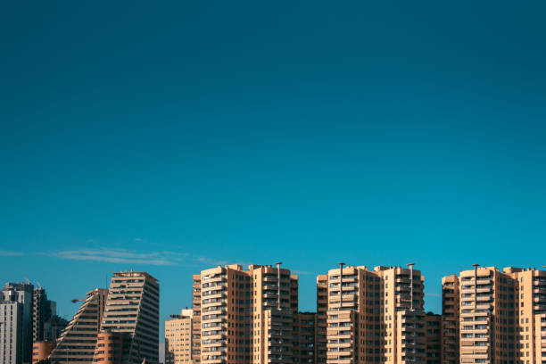 Tall, modern apartment buildings in Valencia, Spain, with copy space in the clear blue sky