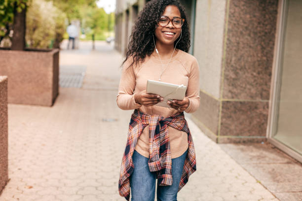 istock International student with backpack, headphones and digital gadgets 1042447198