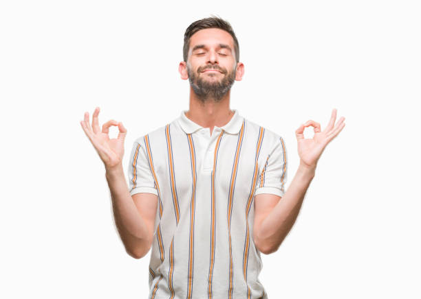 istock Young handsome man over isolated background relax and smiling with eyes closed doing meditation gesture with fingers. Yoga concept. 1042450798