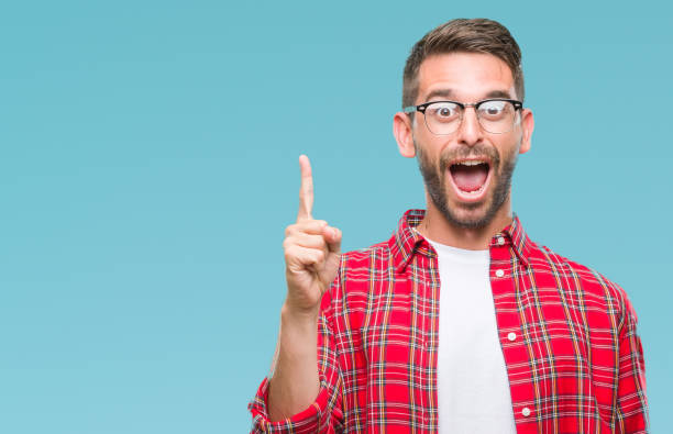 istock Young handsome man over isolated background pointing finger up with successful idea. Exited and happy. Number one. 1042451014