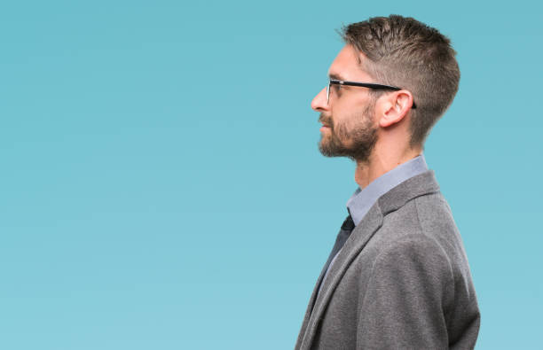 istock Young handsome business man over isolated background looking to side, relax profile pose with natural face with confident smile. 1042451356