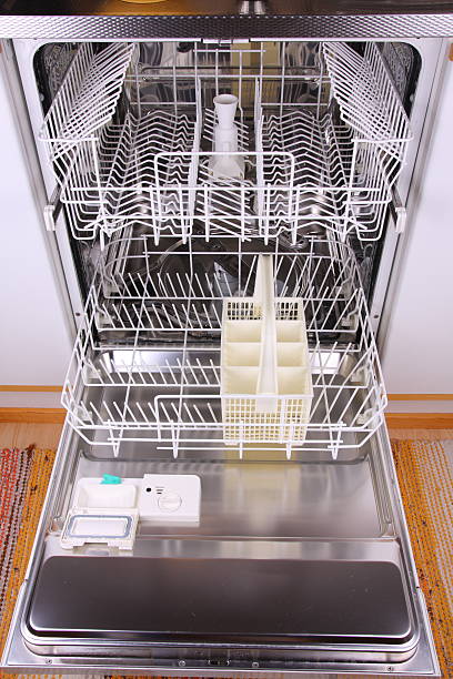 Open empty dishwasher stock photo