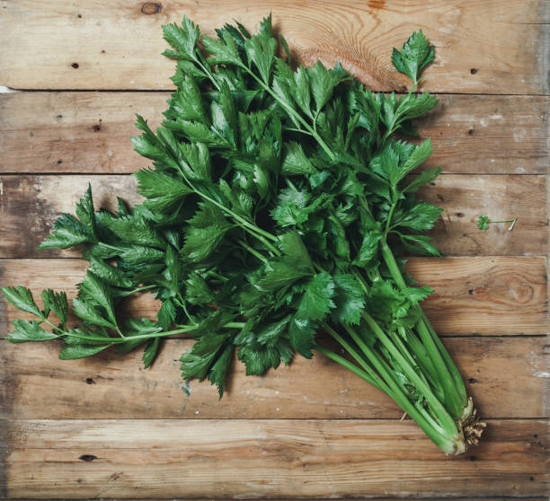 istock Two bunches of celery lie on boards 1042462452