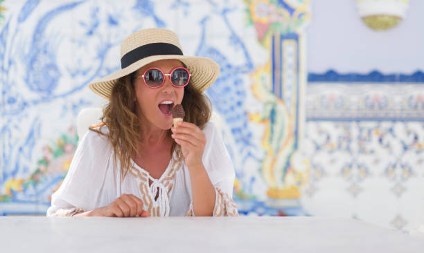 istock Middle age brunette woman eating ice cream with a confident expression on smart face thinking serious 1042466650