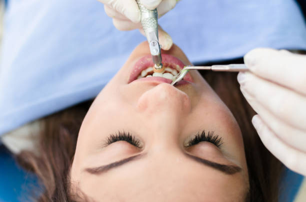 istock Young patient at dentist polishing her teeth 1042470040