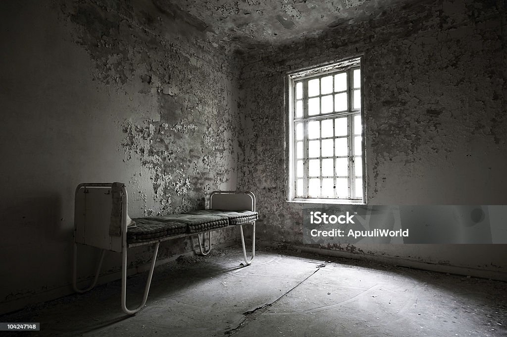 Abandoned hospital with a bed in the corner From an abandoned psychiatric hospital Hospital Stock Photo