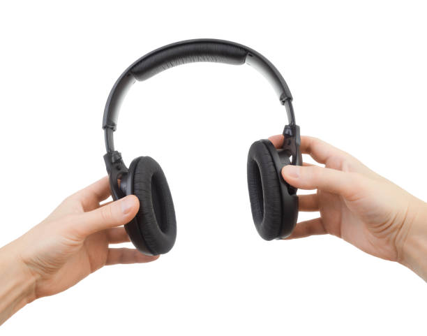 istock Headphones in hands on a white background 1042471846