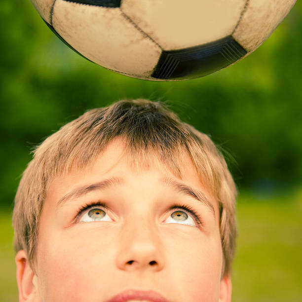 istock boy with soccer ball 104248733