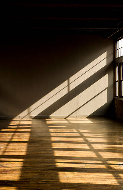 Late day window light streaming thru windows into vacant loft stock photo