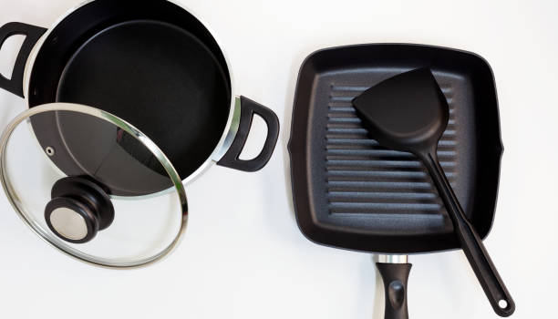 istock pot and pan stainless steel on white background. 1042514642