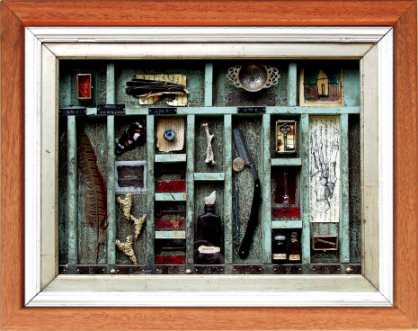 This is an original found object assemblage of my partner's. She has used feathers samples of writing, bones and memorabelia.