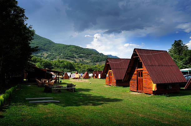 istock Log cabin camping site in the hills with picnic tables 104251565