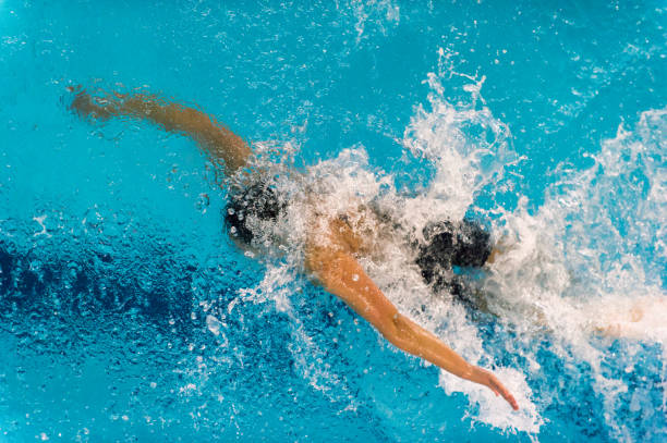 istock High Angle View Of Man Swimming In Pool 1042518154