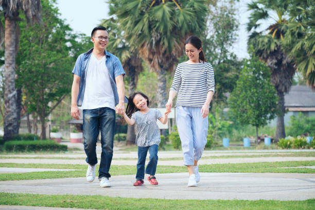 istock Happy Family Walking At Park 1042518810