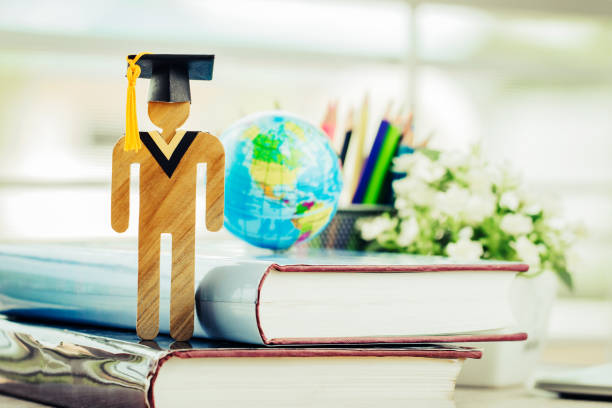 istock Education knowledge learning study abroad international Ideas. Student Sign wood with Graduation celebrating cap open textbook, America global map show alternative studying Back to School Concept 1042533726