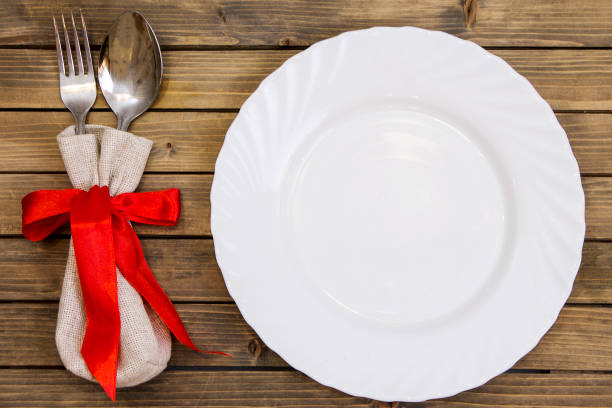 istock Empty dish and cutlery on wooden background closeup 1042538272