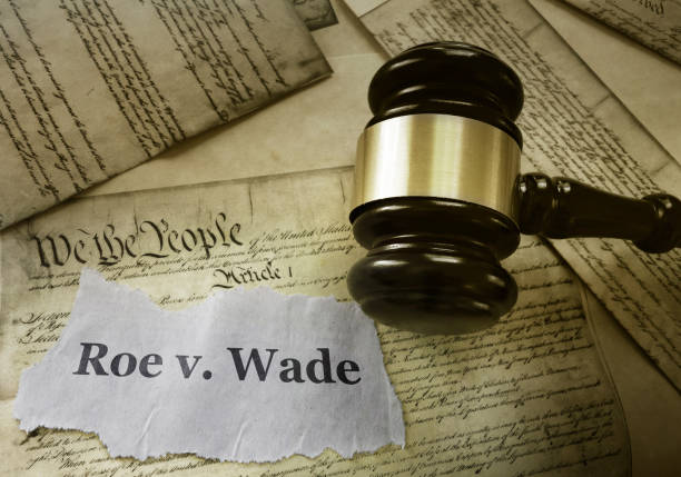 Roe v Wade constitution Roe v Wade news headline with gavel on a copy of the United States Constitution abortion photos stock pictures, royalty-free photos & images