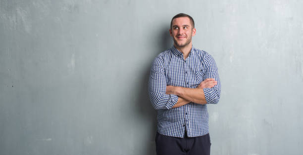 istock Young caucasian man over grey grunge wall smiling looking side and staring away thinking. 1042540254