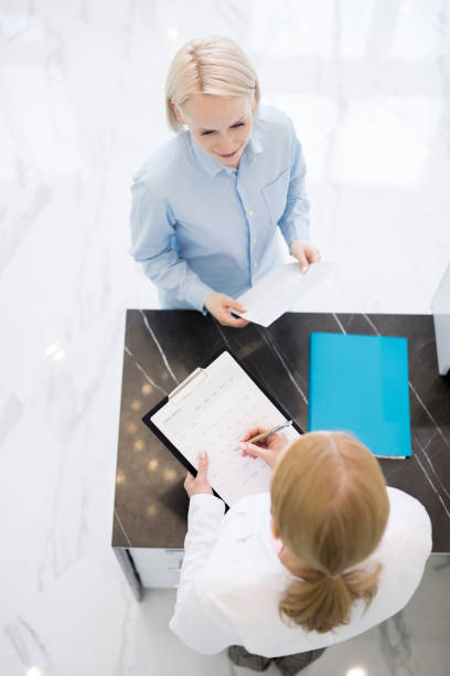 istock Talk of patient and receptionist 1042550894