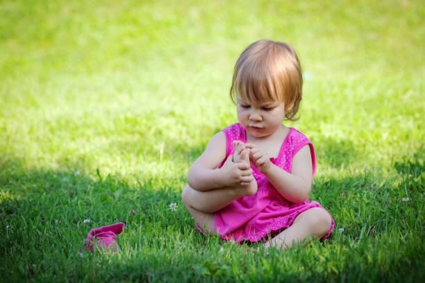 istock little girl playing with toes 1042553734