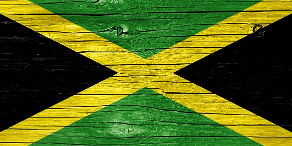 Jamaican flag on wood texture.