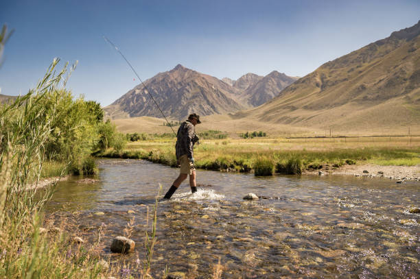 istock Fly Fisherman Hiking To The River 1042562764