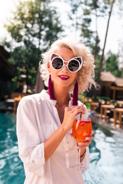 istock Nice attractive blonde woman drinking her cocktail 1042564000
