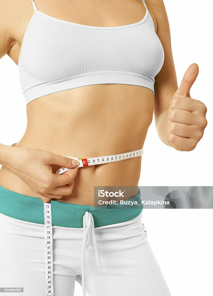 Woman measuring her slim waist with tape measure girl measures  waist and it is pleased her Activity Stock Photo