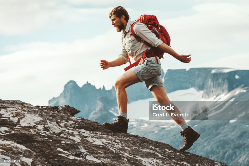 Man adventurer skyrunning in mountains with backpack Norway Travel hiking lifestyle concept active weekend summer vacations athletic person Hiking Stock Photo