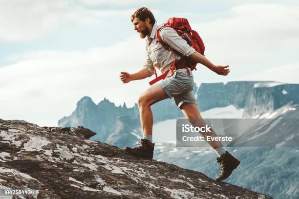 Man Adventurer Skyrunning In Mountains With Backpack Norway Travel Hiking Lifestyle Concept Active Weekend Summer Vacations Athletic Person Stock Photo - Download Image Now