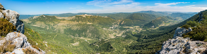 Panorama of the Duilhac-sous-Peyrepertuse commune in the Aude department in southern France, showing the valley beneath, through the village of Duilhac and across to Cucugnan.