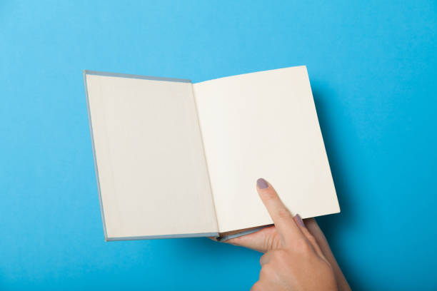 istock Open old book mockup, brochure in hands 1042588568