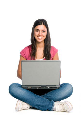 Happy smiling latin girl working on laptop isolated on white background.