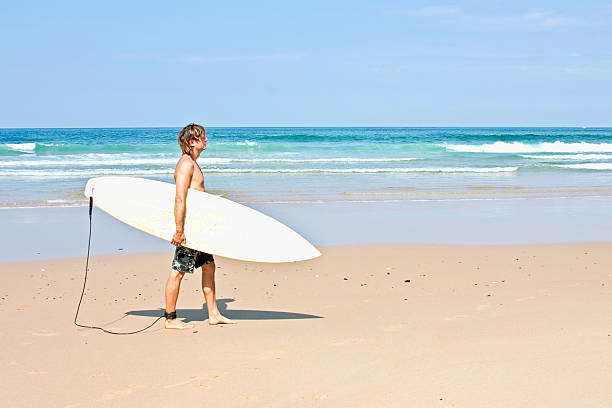 istock Surfer and his surfboard at the beach ready to surf 104258987