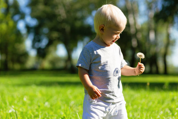 istock Happy kid holding a flower in the hand 1042590102