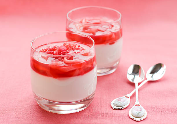 sweet curd mass whipped with fresh strawberries in a bowl, on a wooden table.