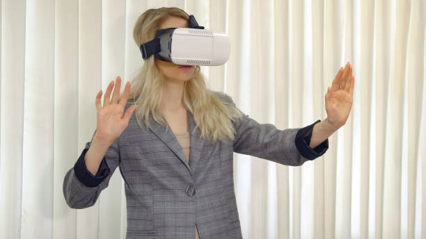 istock Senior woman architect or client using vr glasses to imagine or design a project standing in the office. 1042592170