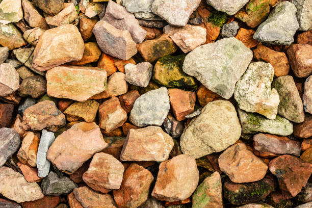 istock Scattered multi-colored stones for modern background texture and graphic use. 1042592674