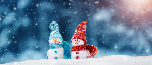 istock little snowmans on soft snow on blue background 1042599672