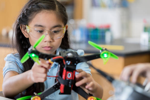 istock Focused schoolgirl builds quadcopter 1042602780