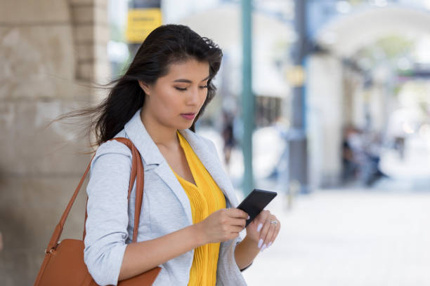 istock Businesswoman uses ride share app 1042602864