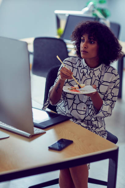 istock Businesswoman Eating in Her Office 1042603270