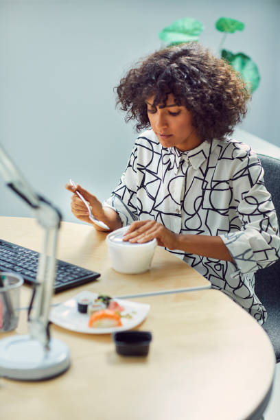 istock Businesswoman Eating in Her Office 1042603312